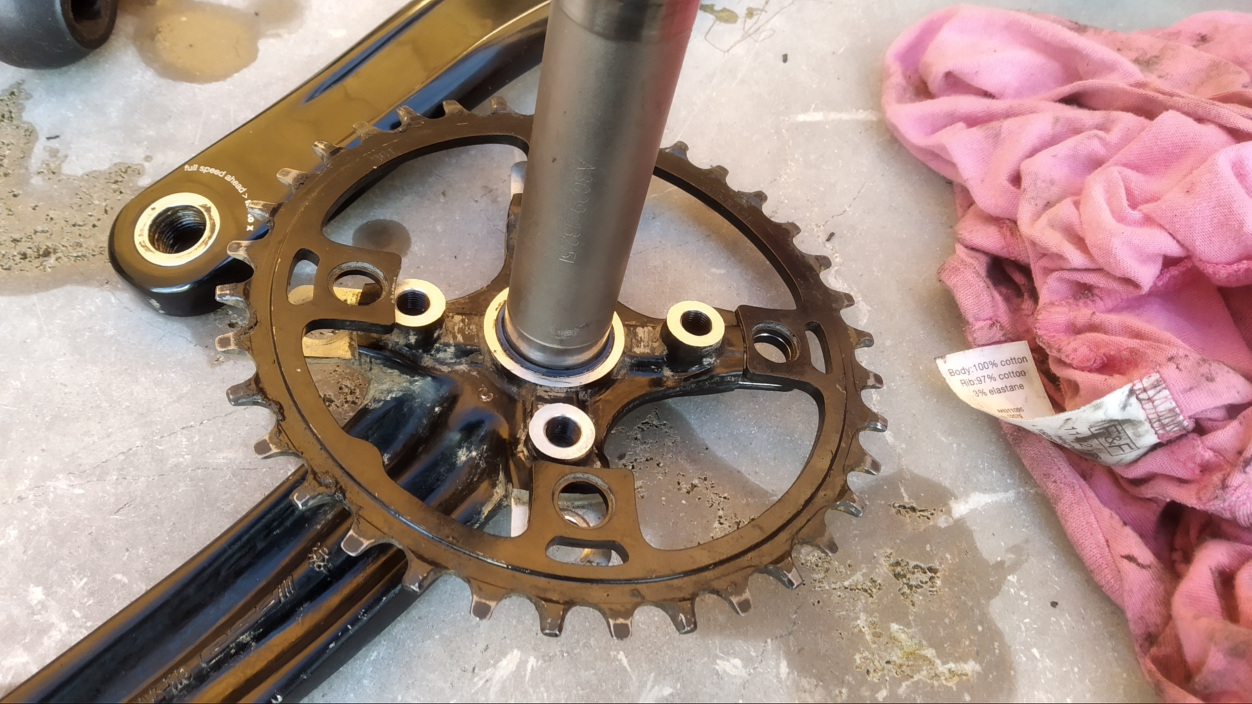 The chainring from the old cranks fitted to the new ones showing that it doesn't fit.