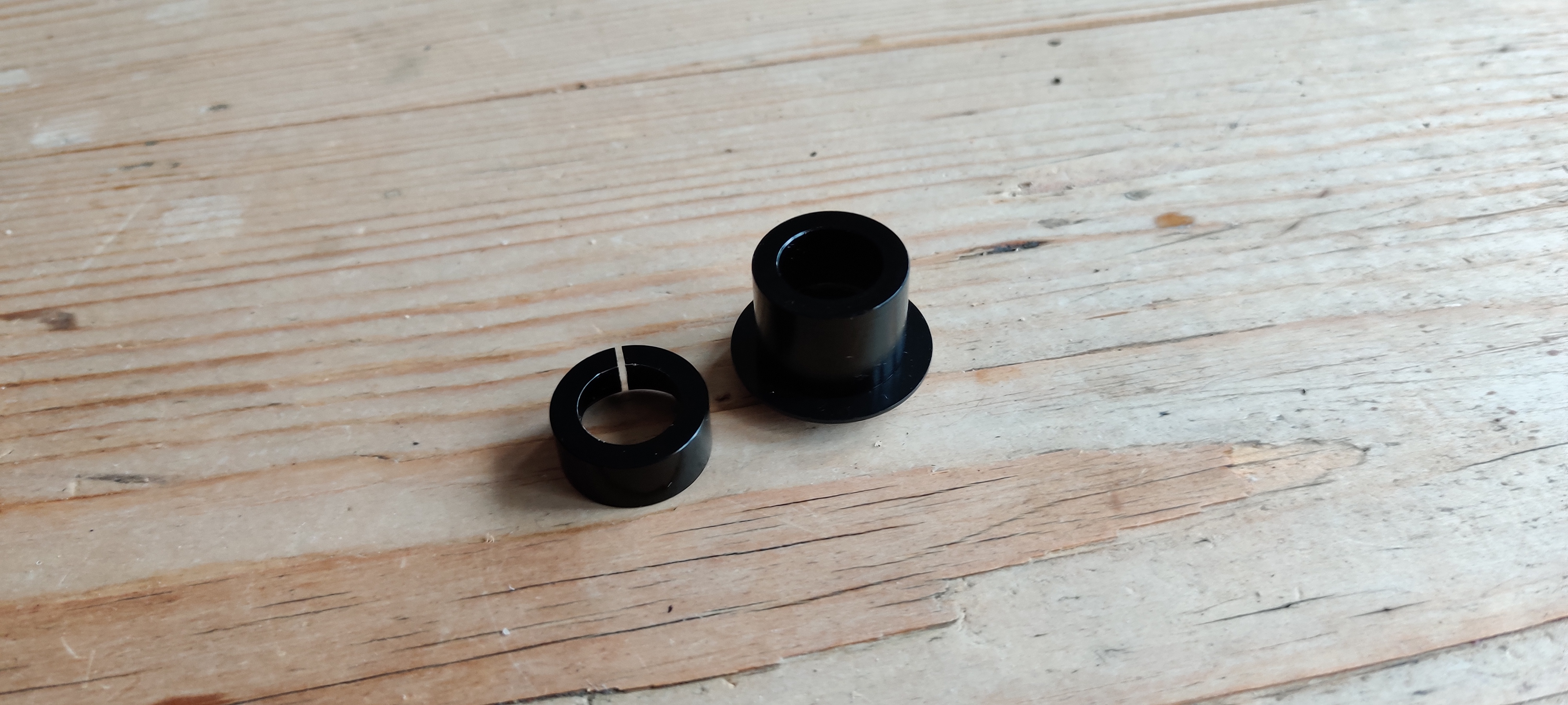 Two black endcaps for a thru axle hub