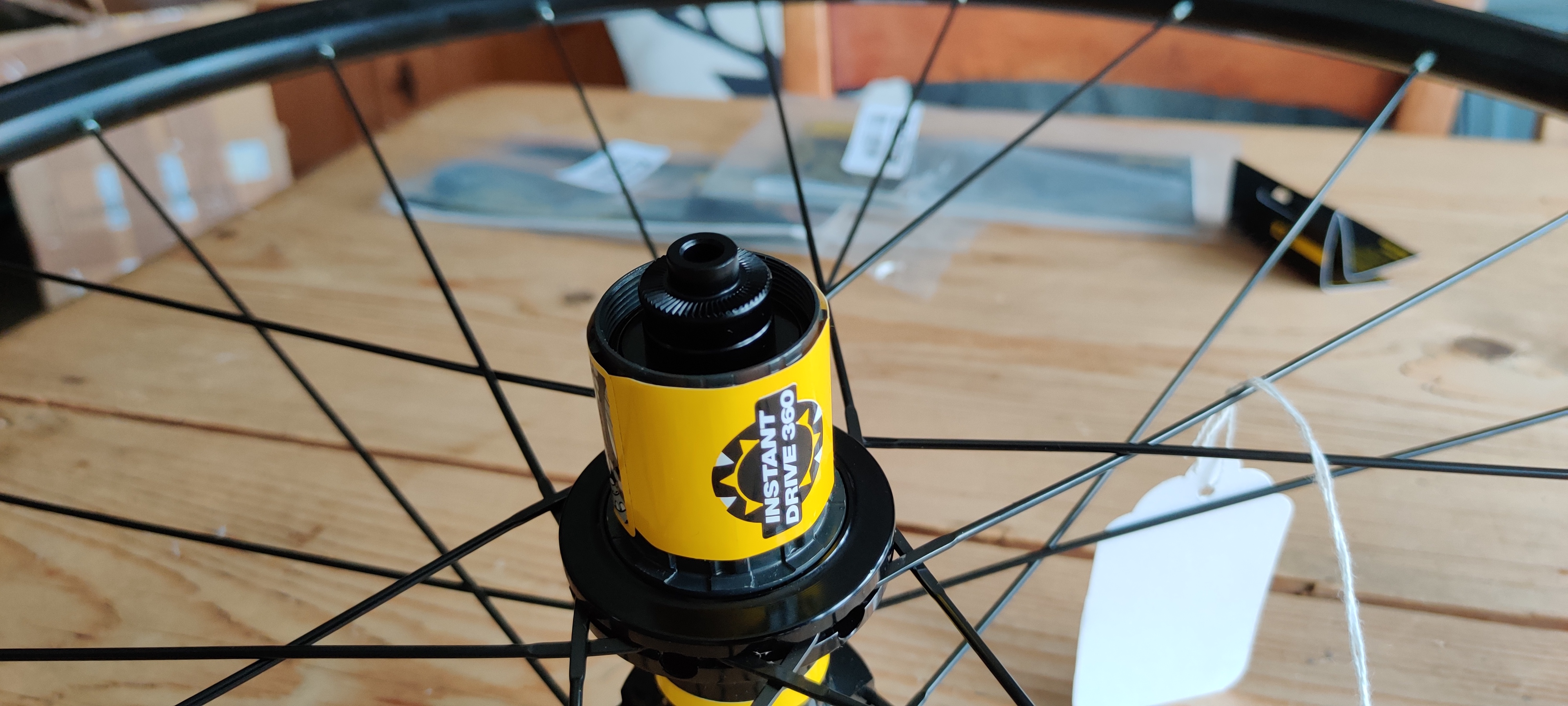 The drive side of the hub with a yellow 'infinite drive' sticker on it. It has the narrower QR endcap on it.