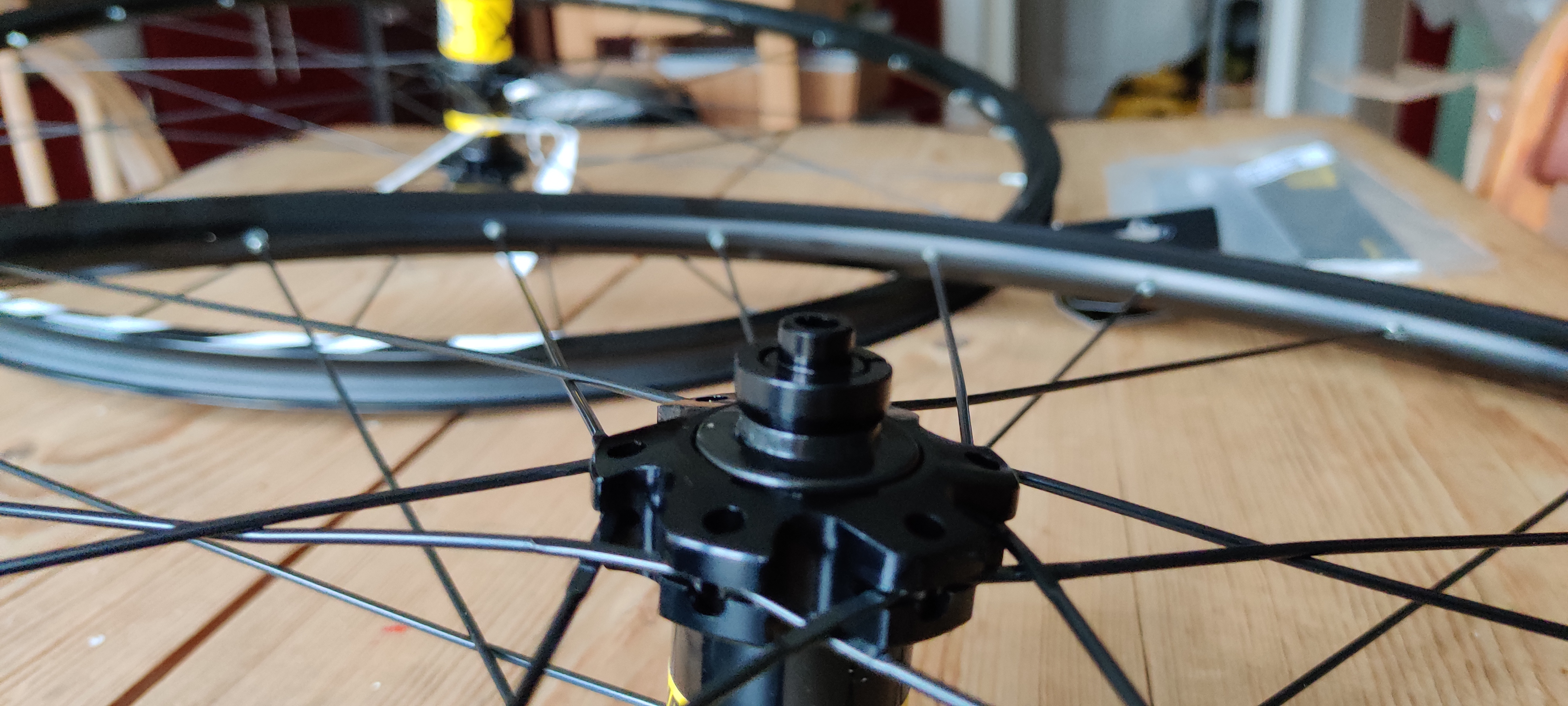 The hub of a bike wheel with a small quick release adapter in the end