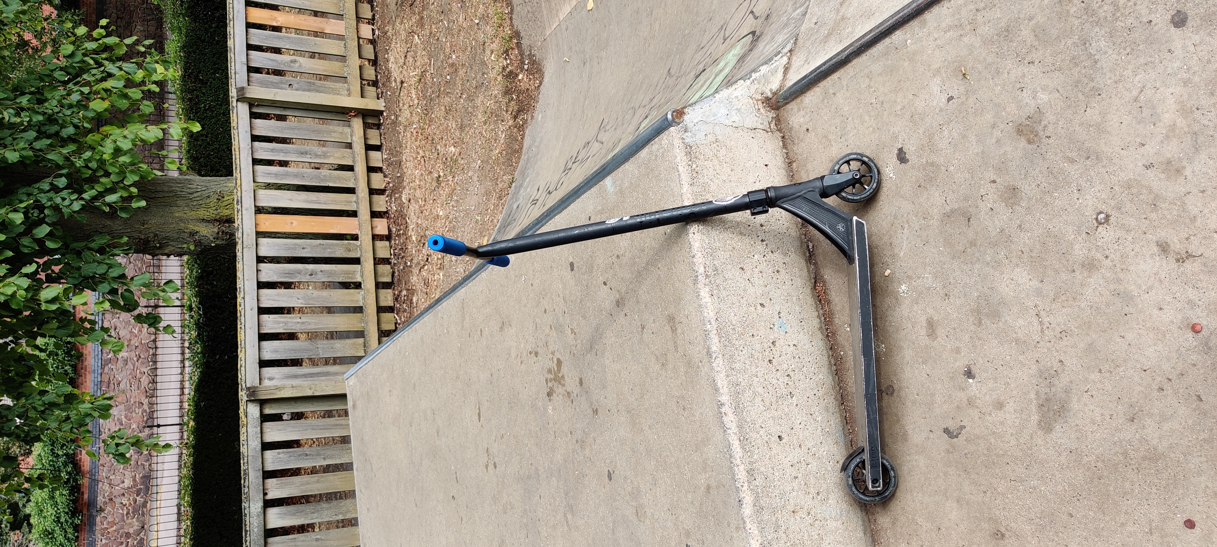 Scooter lent against a concrete ramp in the sun