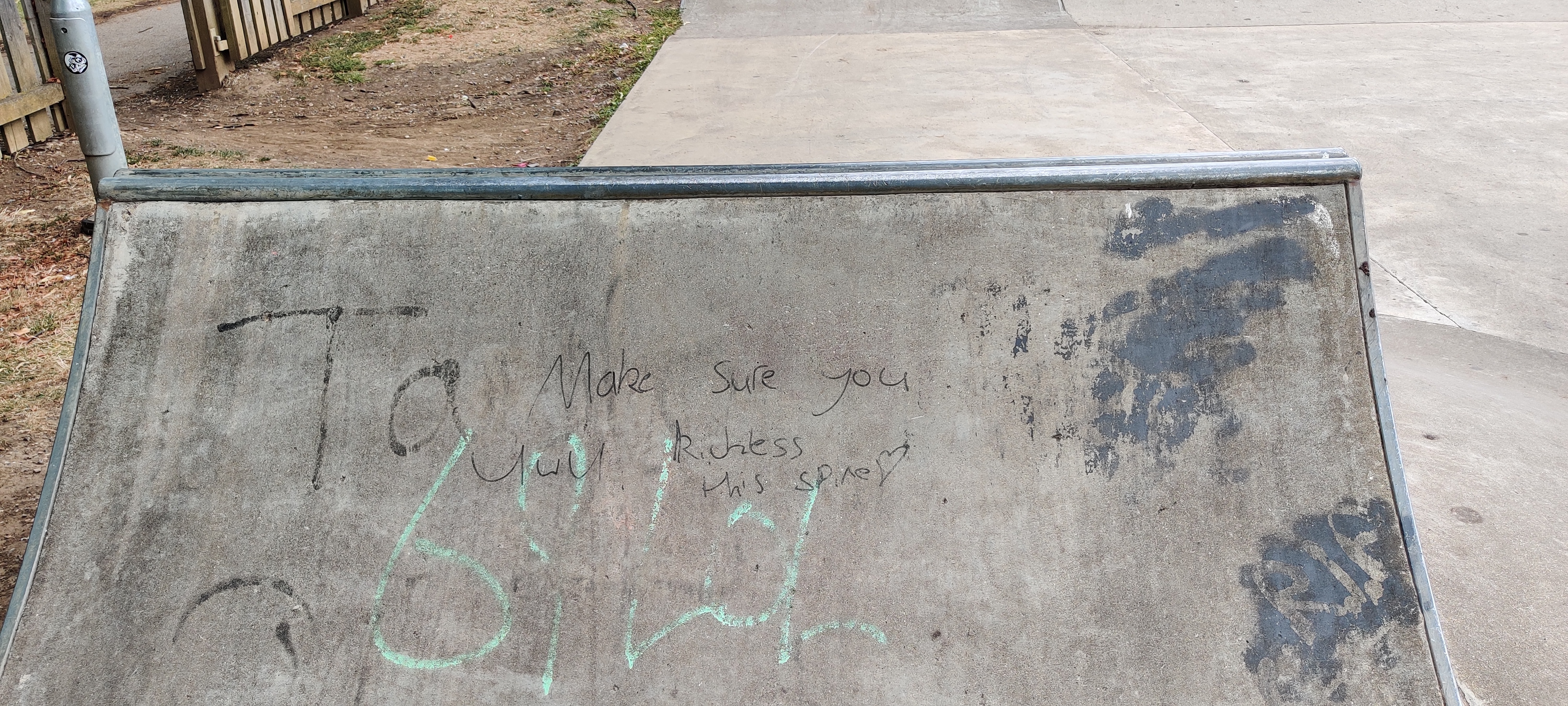 A picture of a bike ramp that's got markered with "don't forget to uwu" and "kickless the spine"