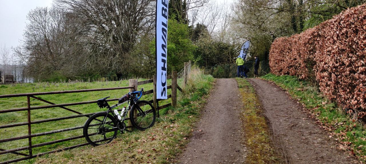 The Manor Farm sector exit (into Owston, looking down the way the riders come from). It's a gravel road, with grass down the middle. My bike sits against the fense, and there's a few Schwalbe flags in the outside as markers for corners